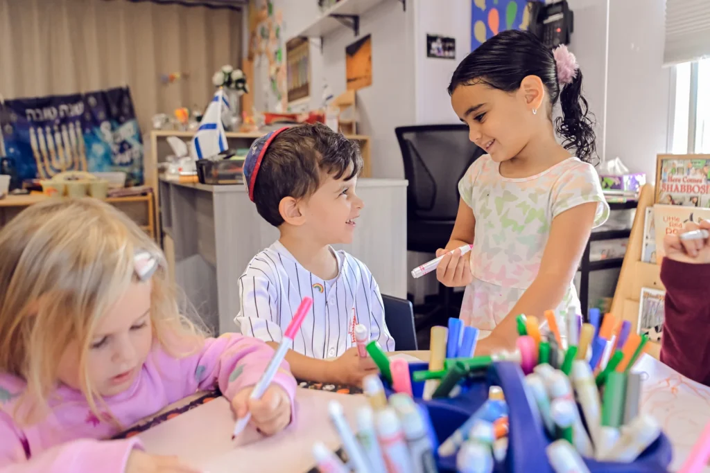 OCA children learning and creating together in their classroom