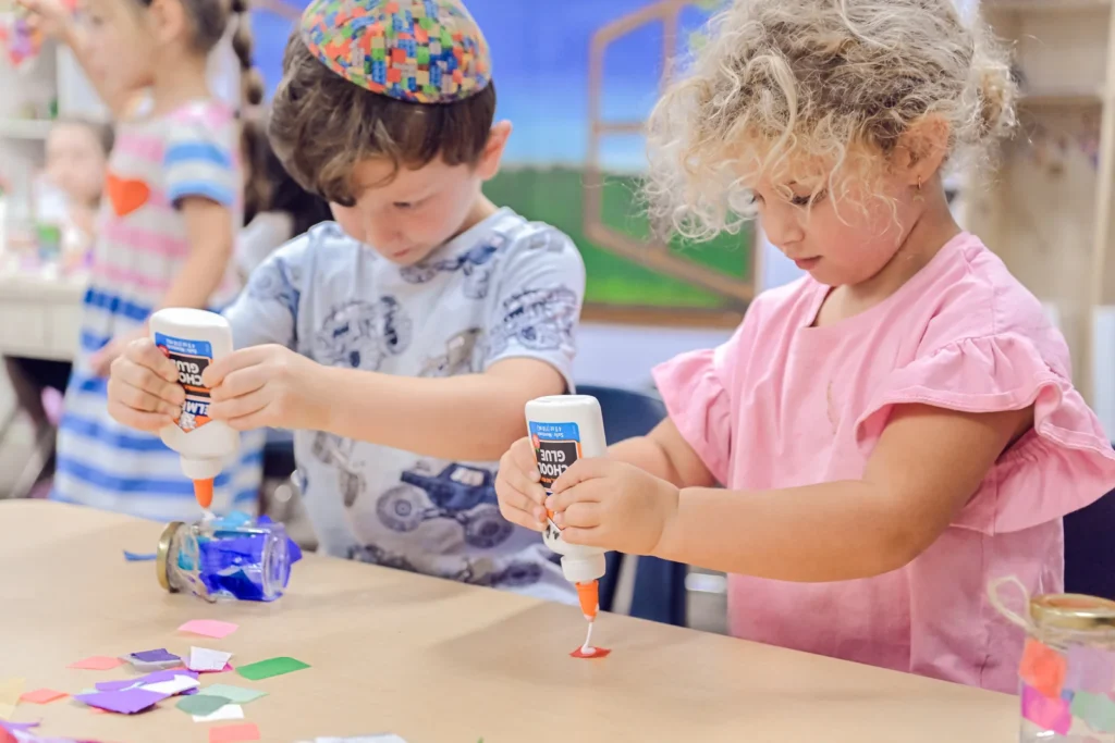 OCA children working on a classroom art activity